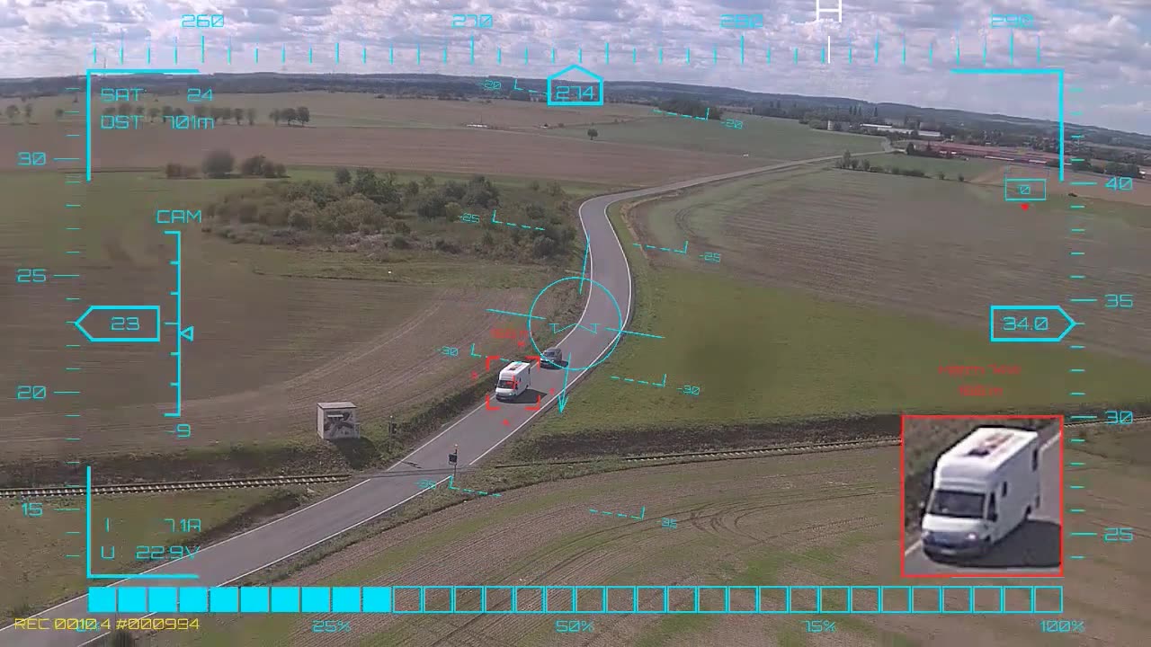 White motorhome by the railway line — onboard AI target lock and real-time tracking from a UAV, FPV goggles DVR